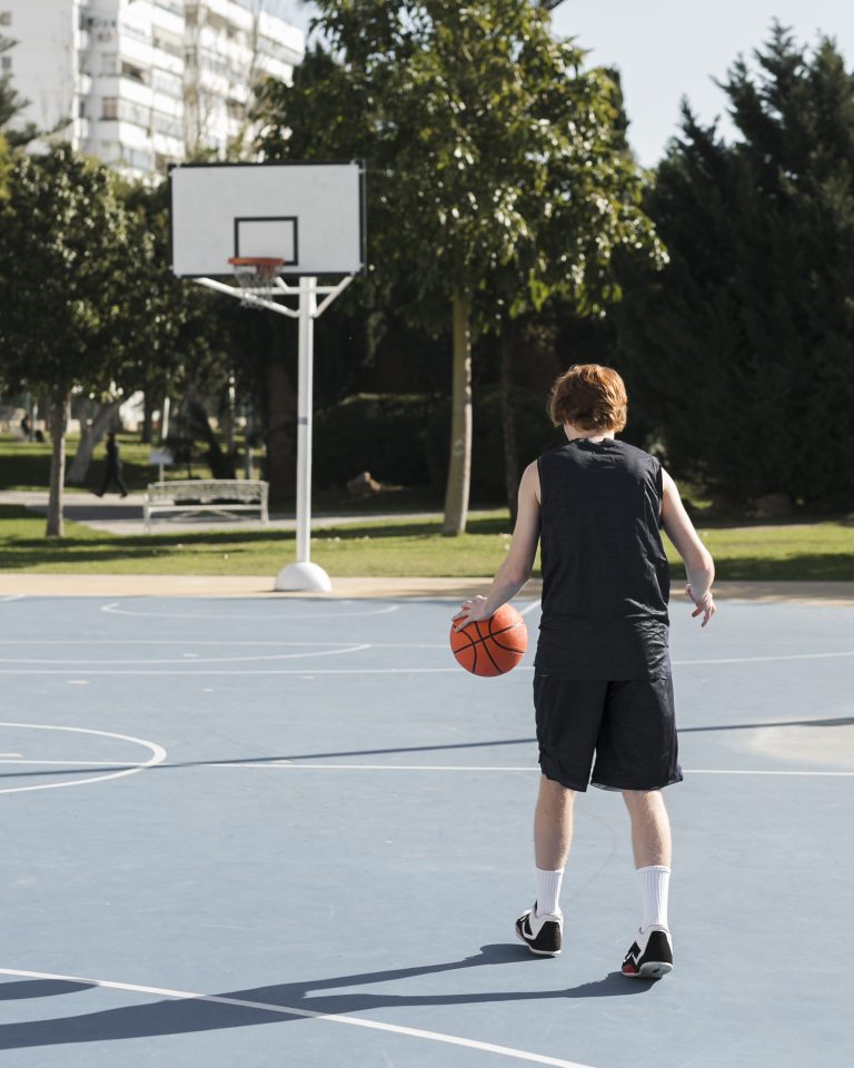 long-shot-boy-playing-basketball